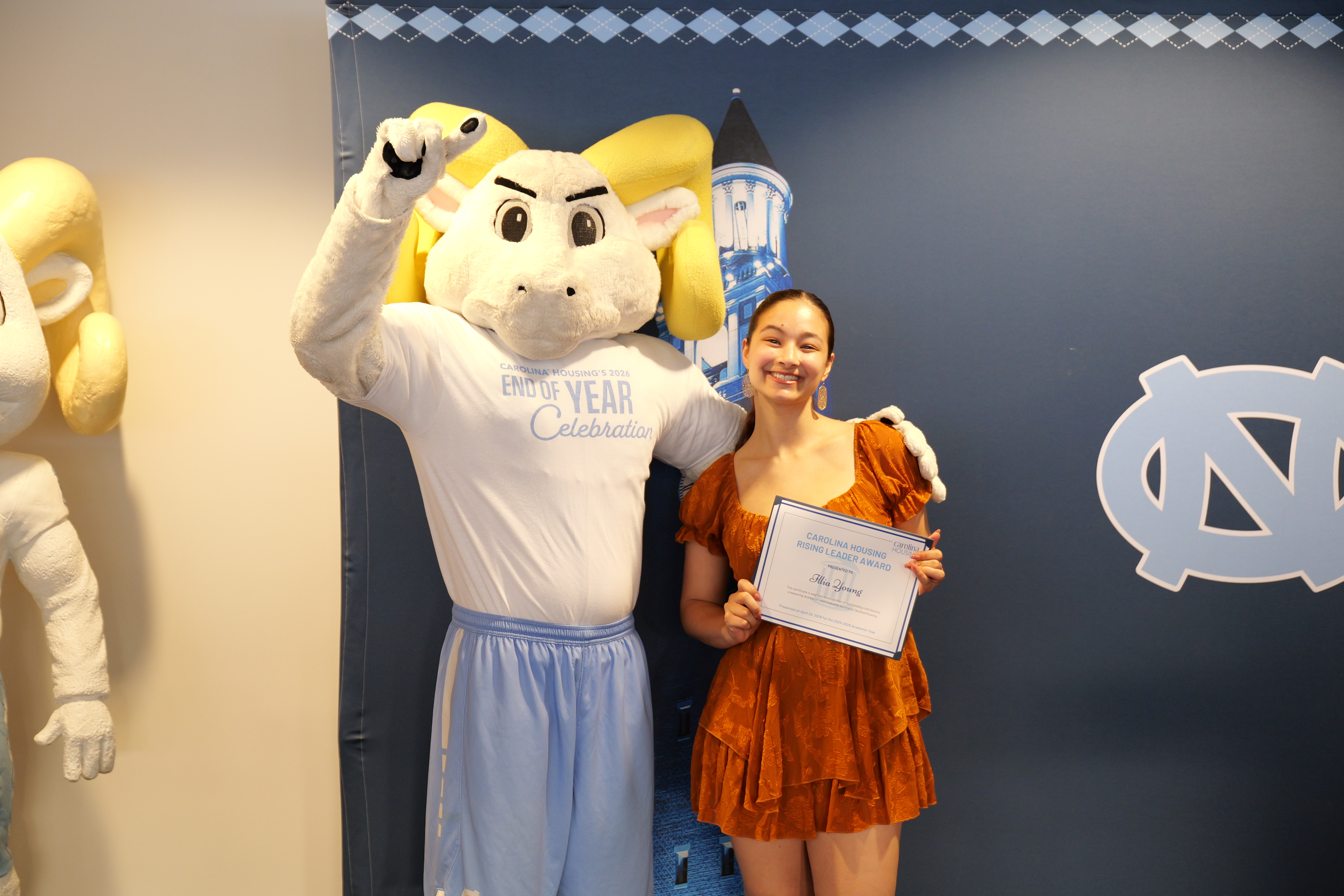 Ilia posing with Rameses with a Carolina Housing Award.