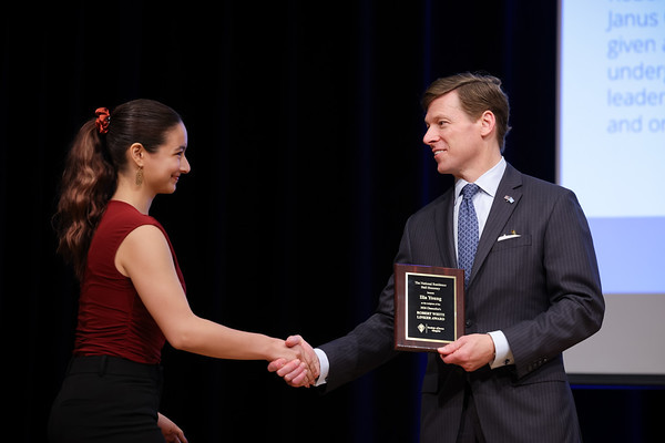Ilia Young shaking hands with the University of North Carolina at Chapel Hill's Chancellor, Lee Roberts.